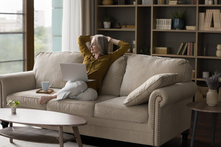 Woman relaxing at home while browsing online, representing flexible ordering without autoship on Freedom ship pass