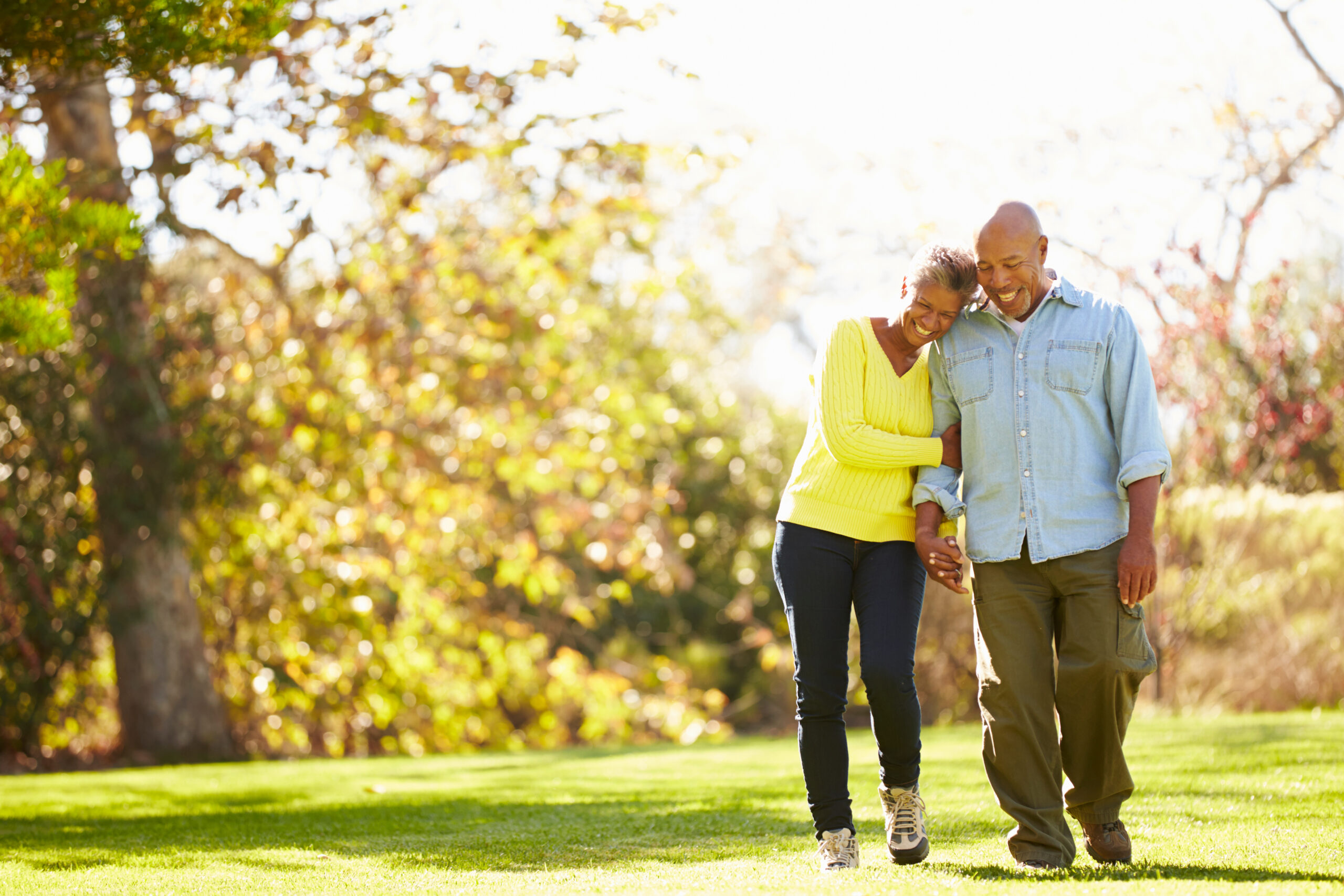 Active adults walking outdoors with good posture illustrating healthy habits for losing height after 50 and supporting bone health.
