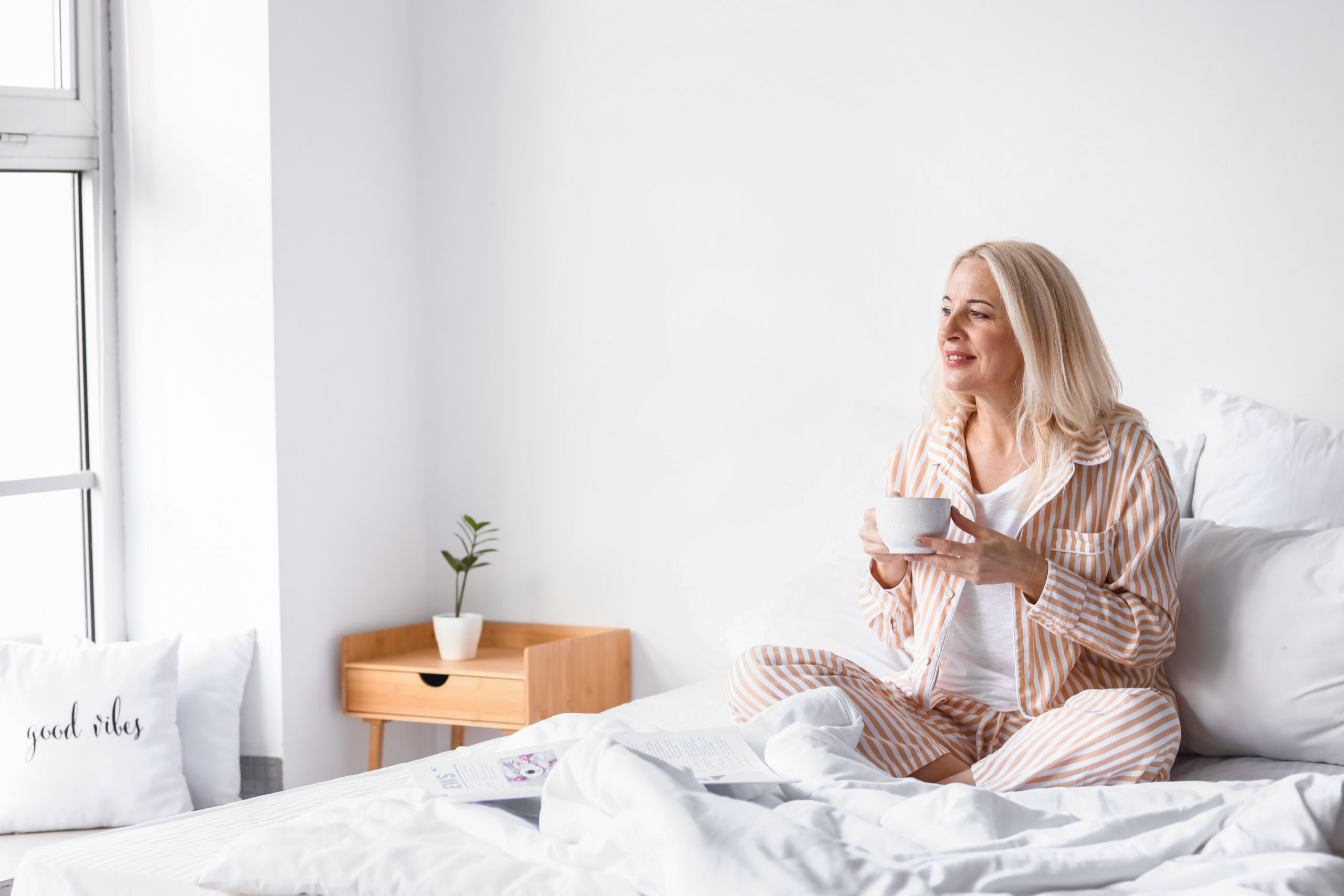Why hot flashes feel worse at night—healthy woman enjoying a comfortable and restful night's sleep during menopause.