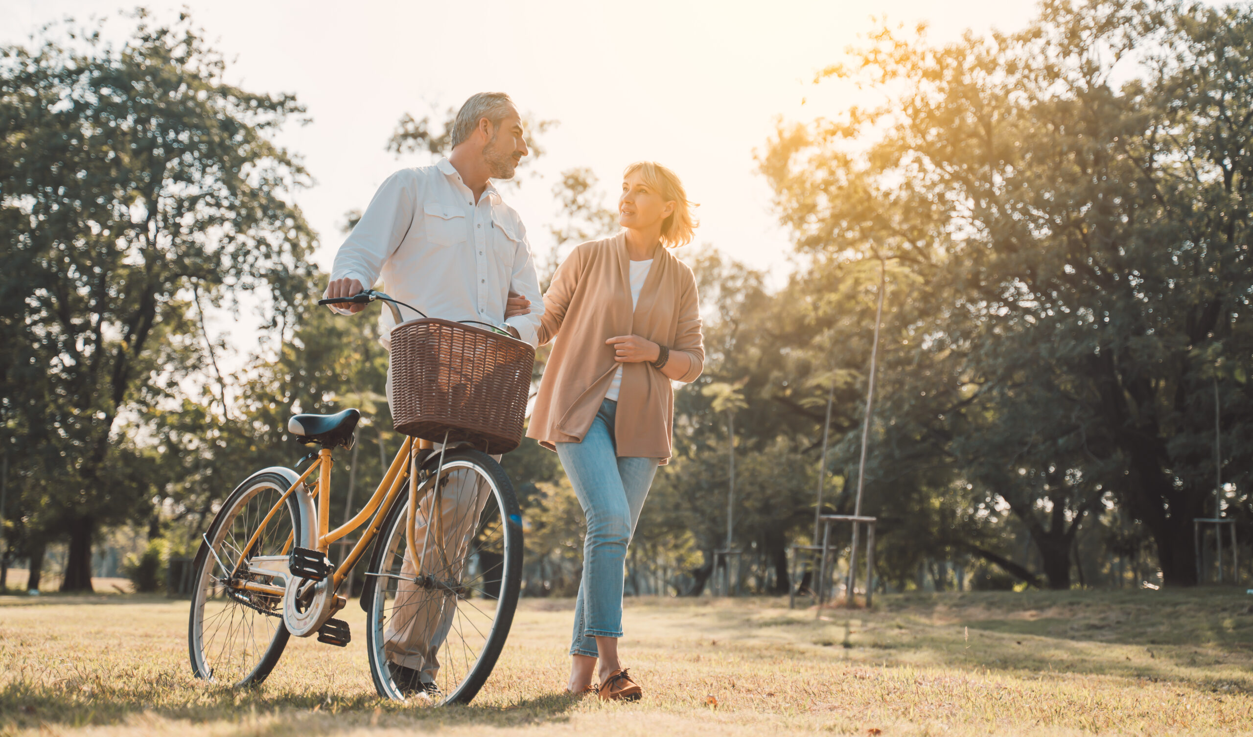 Healthy couple enjoying a walk outdoors while learning how the gut microbiome changes after 50 and ways to support digestive health.