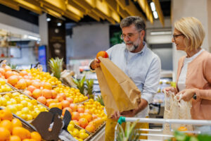 Mature couple choosing fresh fruit as part of a healthy routine for better digestion