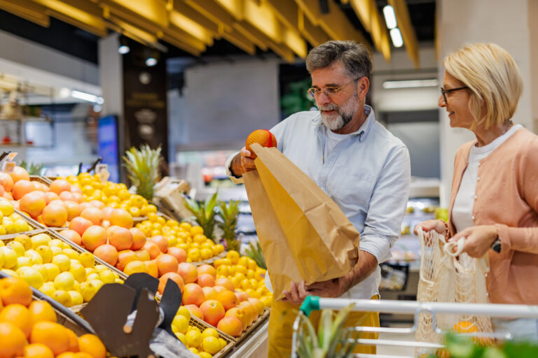 Mature couple choosing fresh fruit as part of a healthy routine for better digestion