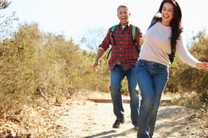 Active couple hiking outdoors as part of a daily routine for stronger bones